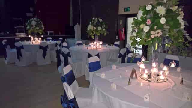 Elegant banquet setup with floral centerpieces in Middleton Arena for evening reception events.