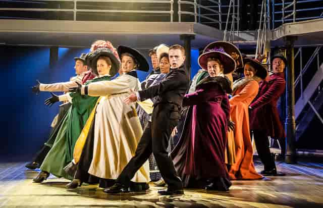 Themed corporate gala with period-accurate costumes at Octagon Theatre Bolton stage.