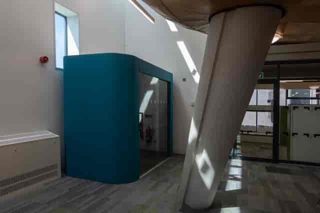 Sound-insulated meeting pod in Peckham Library for private workspace and collaborative office events.