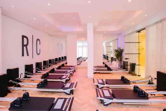Minimalist Pilates studio for corporate wellness activations and team-building retreats.