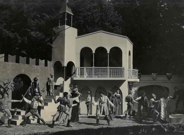 Immersive period theatrical staging at Bedales Theatre for experiential event production.