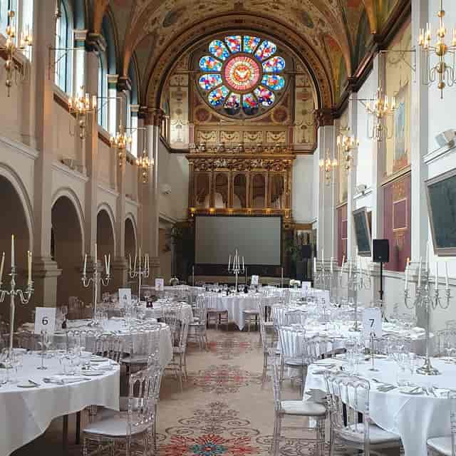 Historic Hurst College banquet hall with round tables for corporate events and conferences.