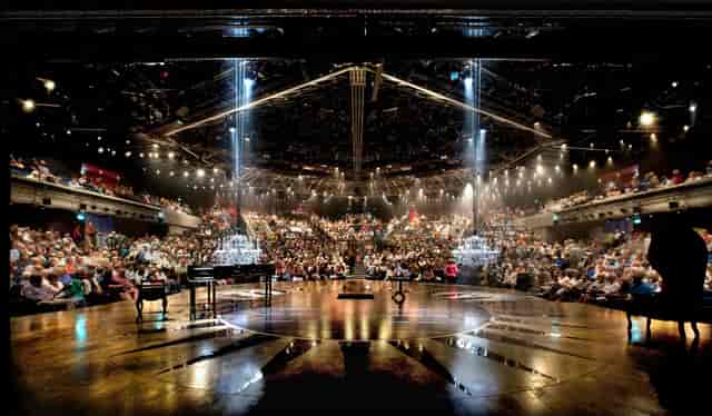 Circular stage with theater seating at University of Chichester plenary event.