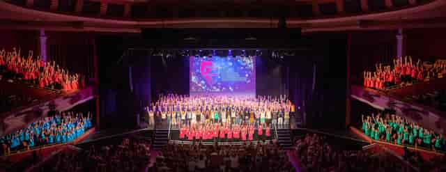 Seaford College Performing Arts Centre closing ceremony on tiered stage for event photography.