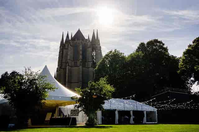 Lancing College Great School architecture featuring marquee event lighting for outdoor weddings.
