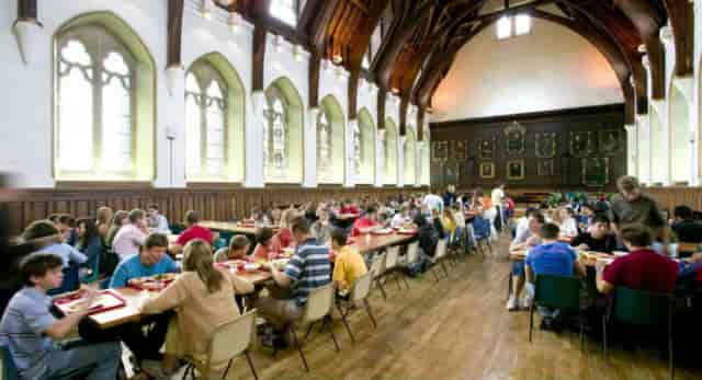 Lancing College dining hall with long banquet tables for student events and corporate dinners.