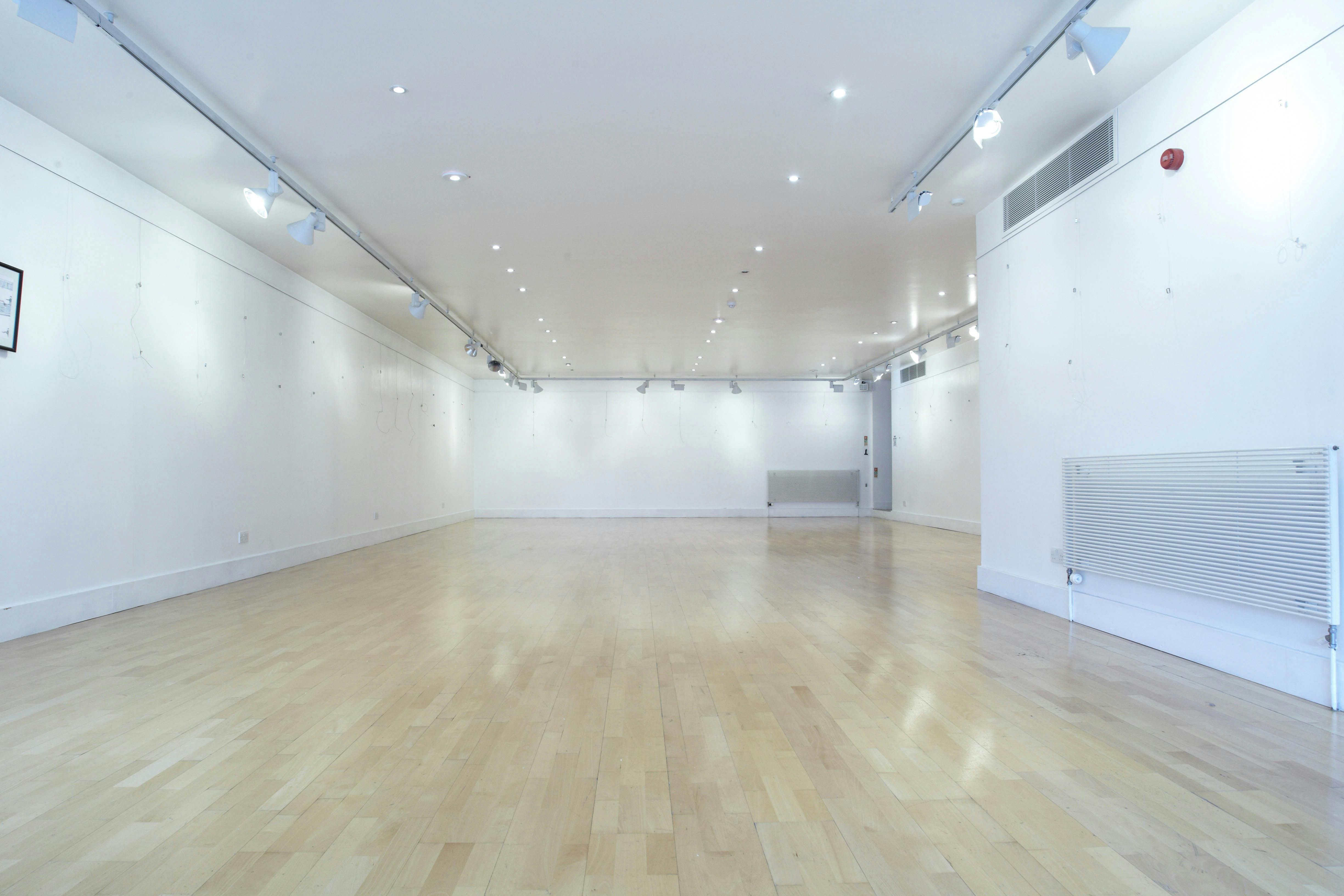 Millennium Art Gallery: versatile event space with polished wooden floor, ideal for workshops and exhibitions.