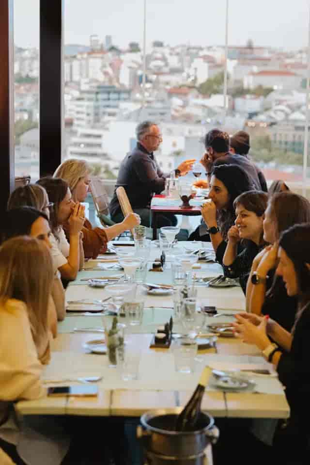 Corporate networking dinner setup at LAV Lisboa ao Vivo with long-table banquet seating.