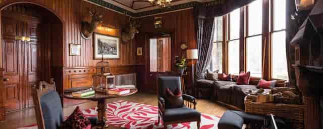 Library at The Torridon: cozy wood-paneled executive retreat for corporate meetings.