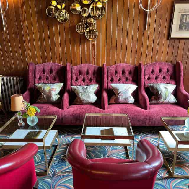 1887 Restaurant at The Torridon featuring tiered wingback seating for corporate networking events.