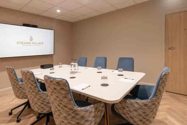 Tech-ready boardroom for six in Soho, Strand Palace, ideal for strategy sessions and meetings.