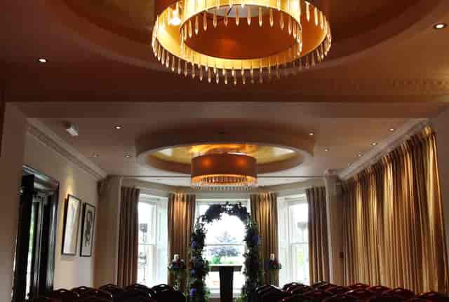 Windsor Suite wedding ceremony setup with floral arch for intimate events and professional meetings.