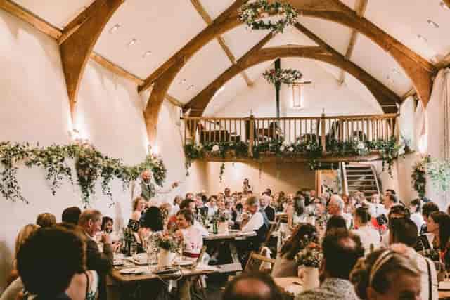 Rustic barn wedding reception at Old Chapel, Ash Barton Estate with banquet seating.