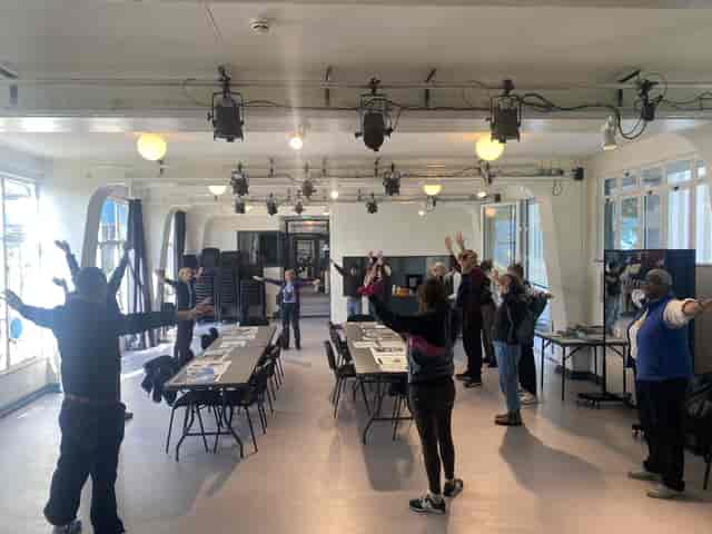 Flexible green room studio for workshops and wellness events.