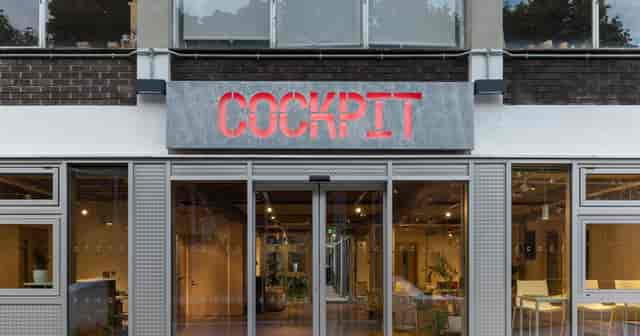 Industrial-style Studio 1 entrance at The Cockpit with backlit marquee for workshops and networking.