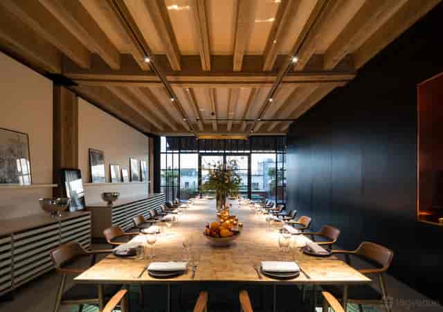 Private dining room with wood-beam ceiling for corporate events and executive meetings.