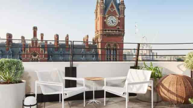 Covered balcony with clocktower view for VIP networking and corporate meetings.