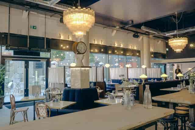 Clocktower View industrial event space with tiered lighting for networking and corporate events.