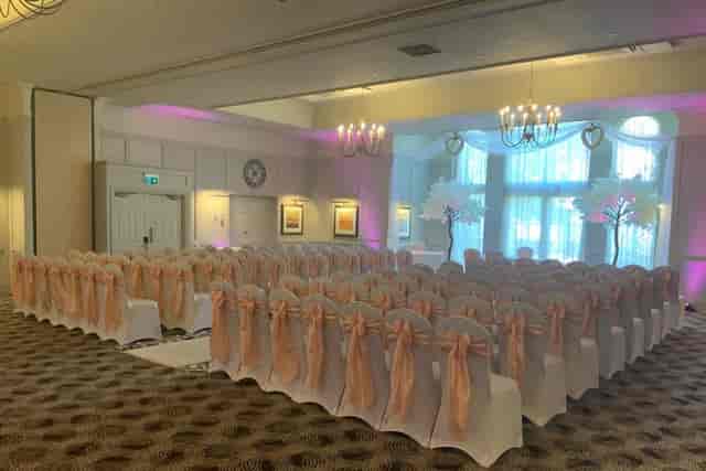 Carrington Suite wedding ceremony venue with peach decor at Holiday Inn Milton Keynes.