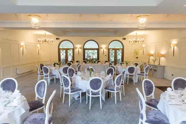 Carrington Suite banquet hall with arched windows for formal events and wedding receptions.