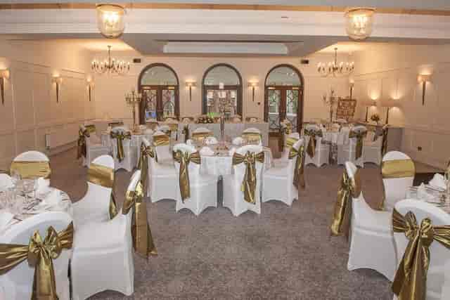 Carrington Suite banquet setup with gold chair sashes, perfect for formal wedding gala dinners.