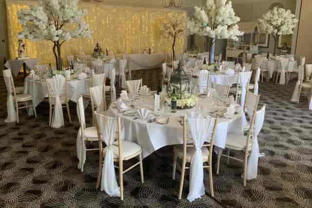 Carrington Suite ballroom with blossom centerpieces for wedding or corporate events.
