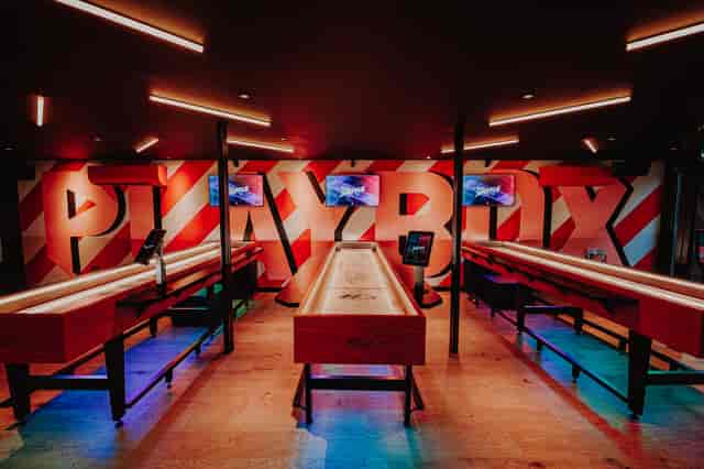 PLAYBOX at Boxpark Croydon: Shuffleboard venue for corporate team building and social networking.