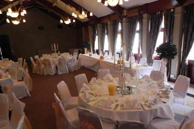 Wedding banquet setup in The Cock Hotel Marquee Suite with elegant circular tables and lighting.