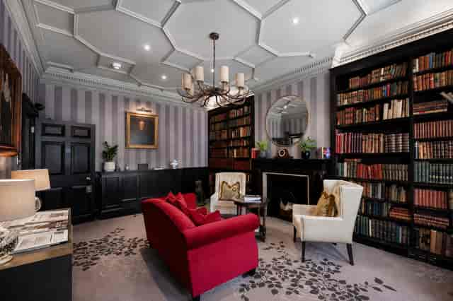 Luxury heritage library meeting space for executive interviews and VIP consultations.