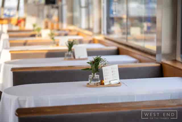 Minimalist banquet setup at WEOTT I for intimate riverside dining and corporate events.