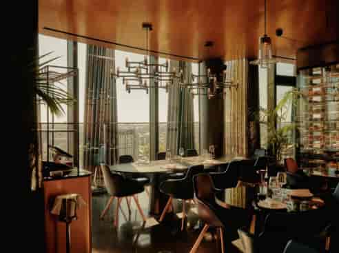 Private dining space at art'otel London Hoxton with floor-to-ceiling views for executive meetings.