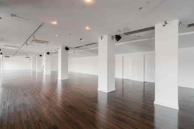 OXO2 blank-canvas event space with white walls and wood floors for corporate or wedding hire.