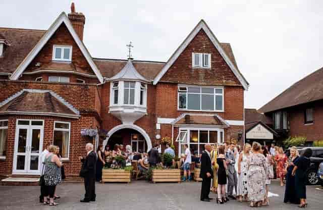 Intimate outdoor drinks reception in The Hickstead Hotel courtyard, ideal for social networking.