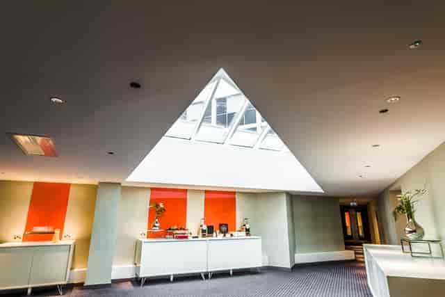 Regent’s Park breakout space at Pullman London St Pancras with skylight for corporate networking.