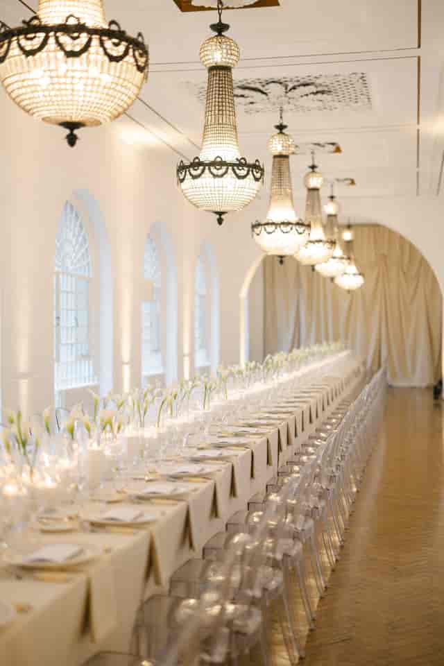 Luxury wedding and gala event space at One Marylebone with crystal chandeliers and long tables.