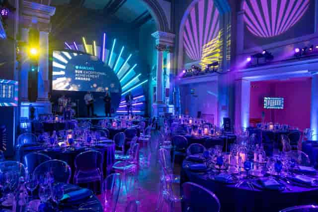 One Marylebone awards gala featuring modern acrylic seating and immersive blue stage lighting.