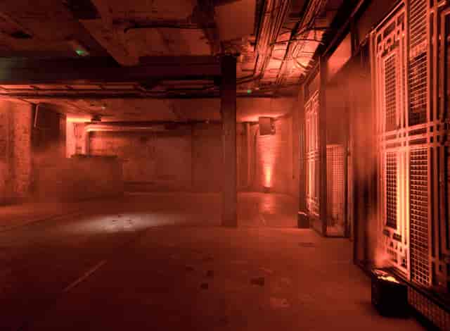 Industrial-chic event hall with atmospheric lighting for experiential pop-up venue hire.