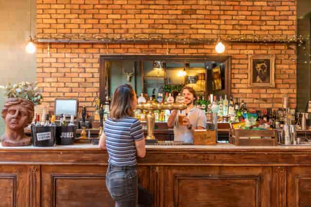 Rustic bar at Behind The Arch Wimbledon, ideal for networking events and post-conference mixers.
