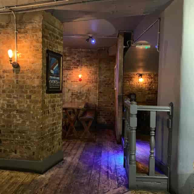 Rustic-industrial private meeting space at Behind The Arch, The Old Frizzle, Wimbledon.