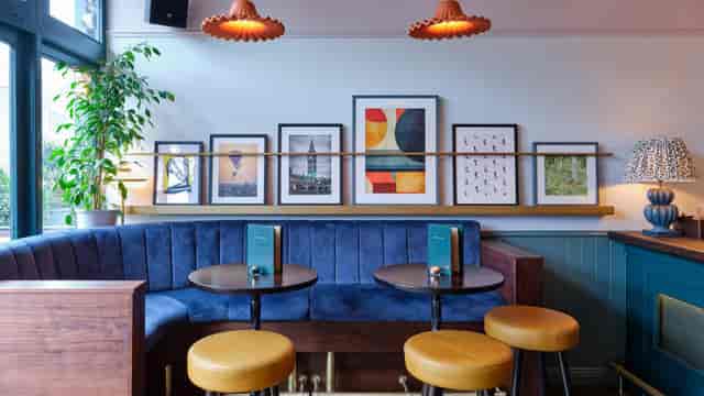 Plush blue banquette at The Old Frizzle Wimbledon, ideal for networking and breakout sessions.