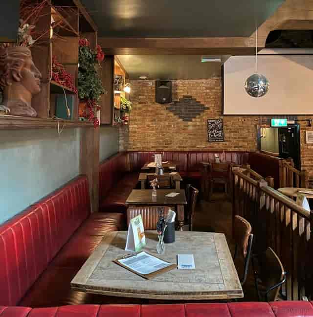 The Balcony at The Old Frizzle: brick-walled private venue for networking and social mixers.