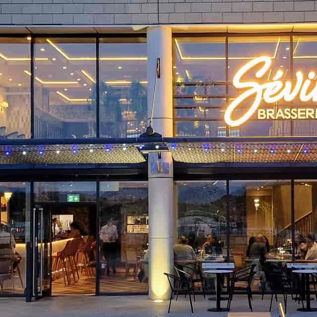 Private restaurant venue with string lighting for networking events and social functions.
