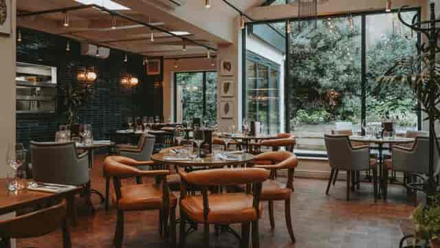 Private Sevine restaurant venue with floor-to-ceiling windows for corporate dinner and networking.
