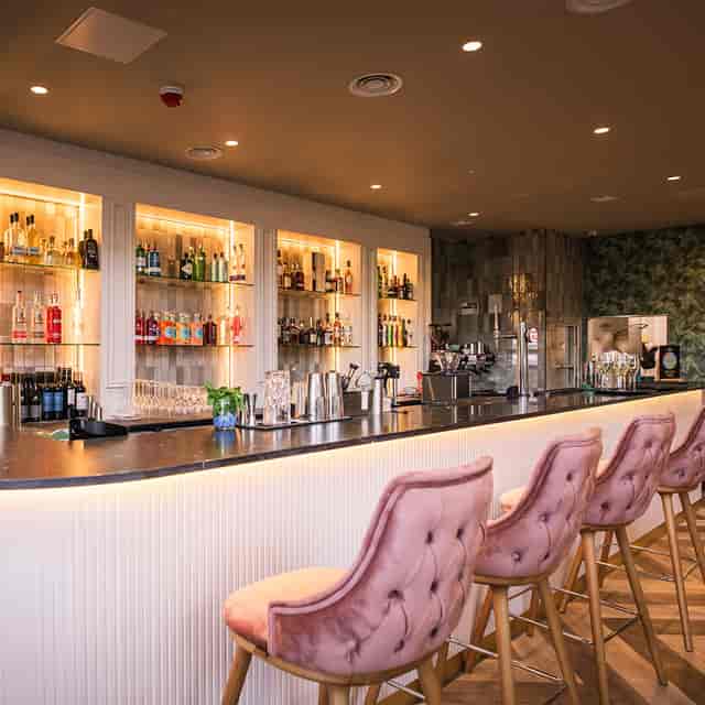 Private restaurant venue with velvet seating for networking receptions and cocktail hours.