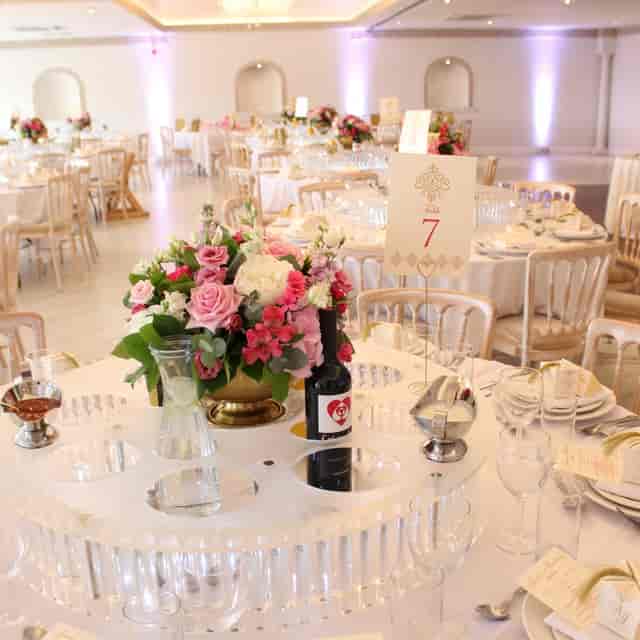 Elegant wedding reception at Sevine restaurant with gold tablescapes and floral centerpieces.