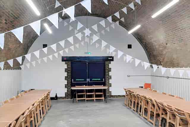 Industrial-chic Studio K event venue with U-shape seating for rustic weddings or corporate meetings.