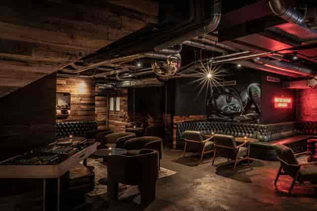 Industrial-chic private bar with DJ booth for high-energy VIP events and evening receptions.