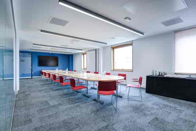 Modern boardroom with hollow-square table for corporate meetings and workshops.