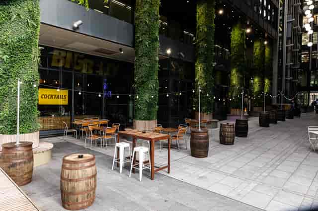 Outdoor terrace with festoon lighting for urban networking events and comedy club receptions.