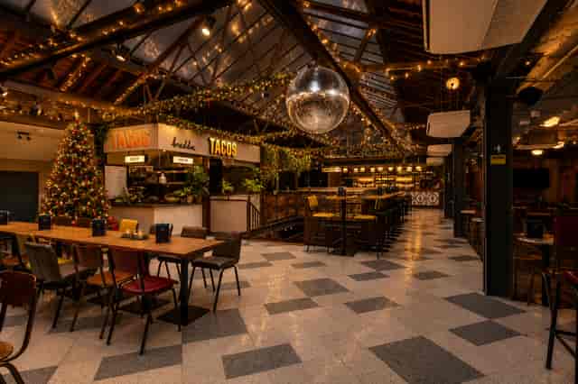 Festive industrial venue with disco ball for corporate Christmas parties and holiday networking.